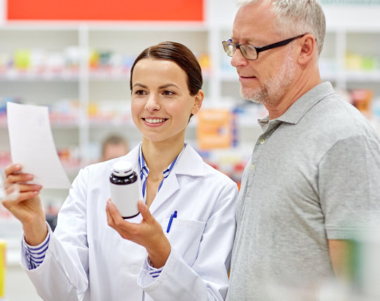 Ricker Pharmacy pharmacist consulting a patient